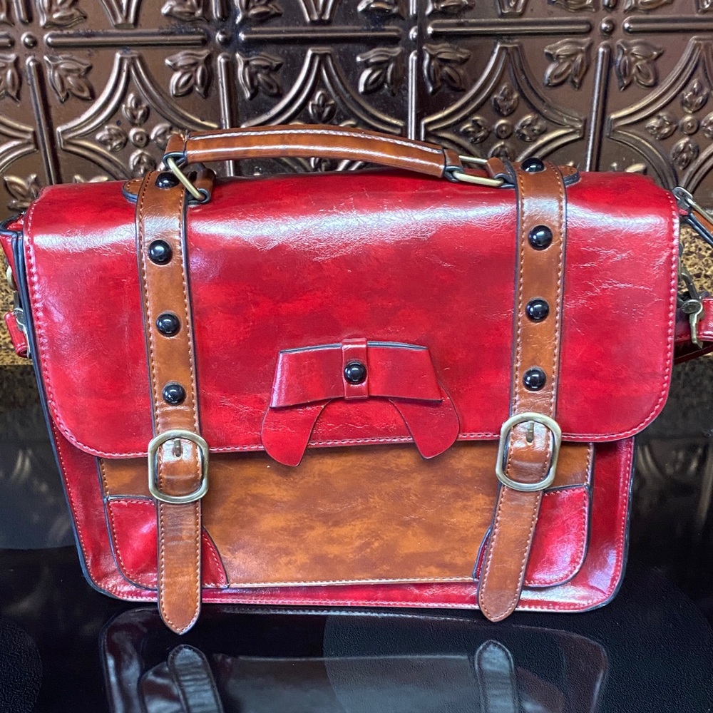 Vegan leather shoulder bag or satchel red @ brown.
Height 10” Length 12 1/2